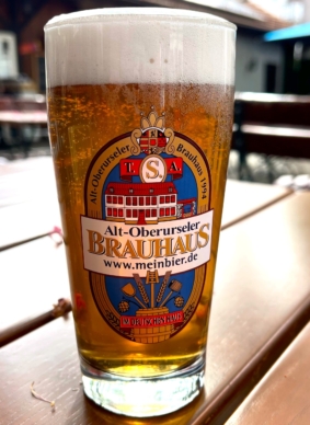 Ein Glas Bier auf einem Tisch im Biergarten.